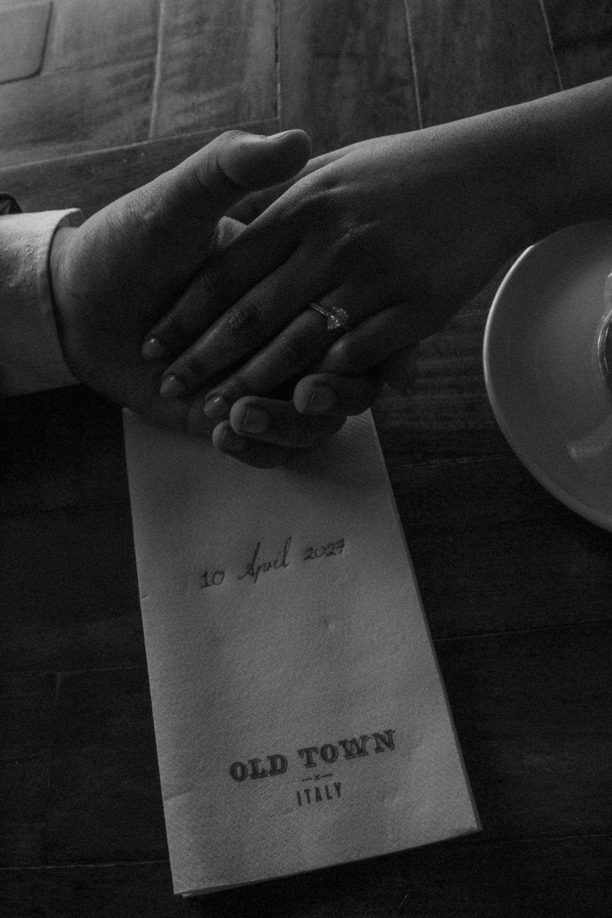 The couple’s hands entwined, her engagement ring catching the light
